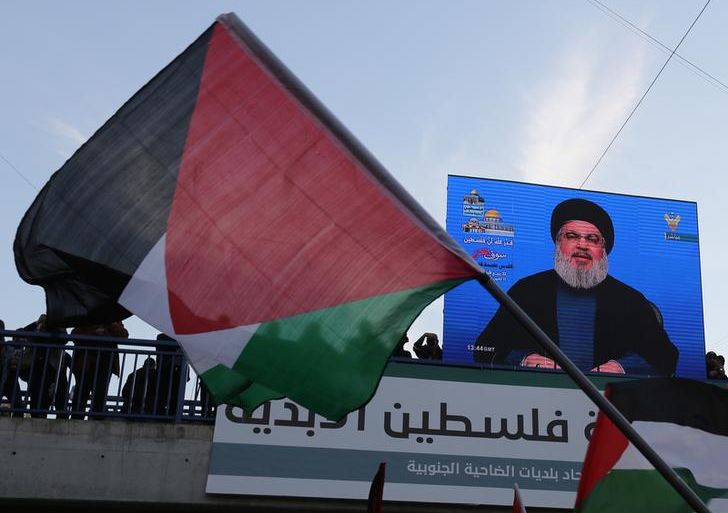 Lebanon's Hezbollah leader Sayyed Hassan Nasrallah speaks via a screen during a protest in Beirut's southern suburbs