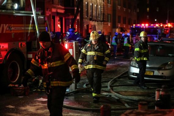 FDNY personnel work on the scene of an apartment fire in Bronx